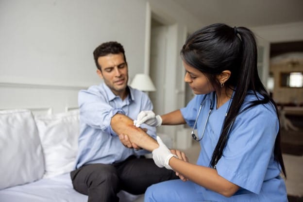 A doctor is cleaning a patient's wound in Beverly Hills, CA, and Seattle, WA